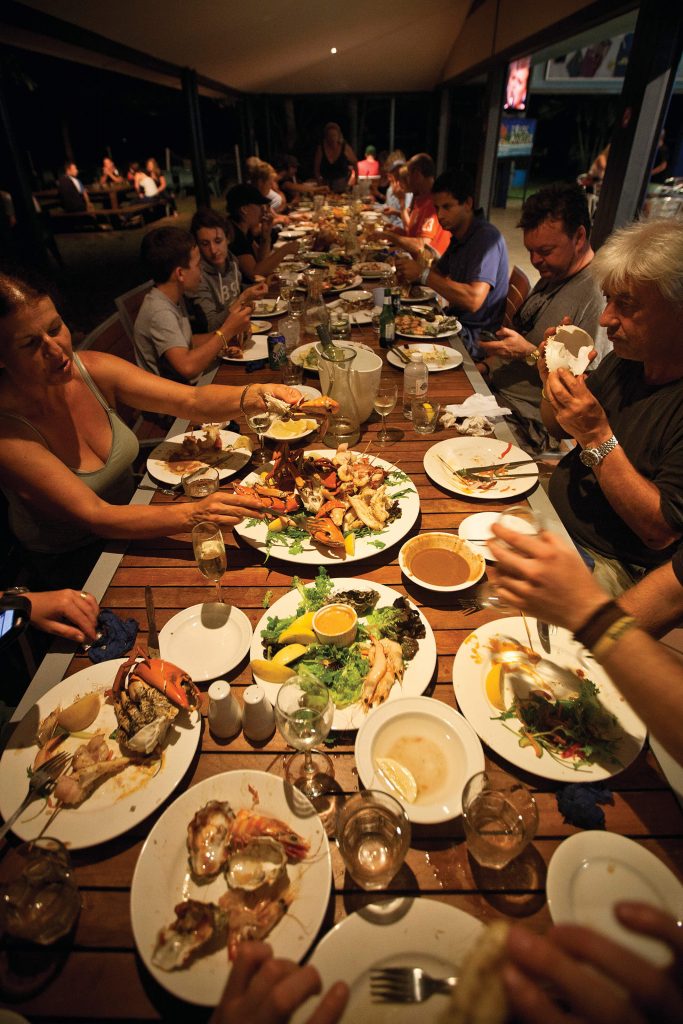 people enjoying dinner at the sunset tavern in karumba