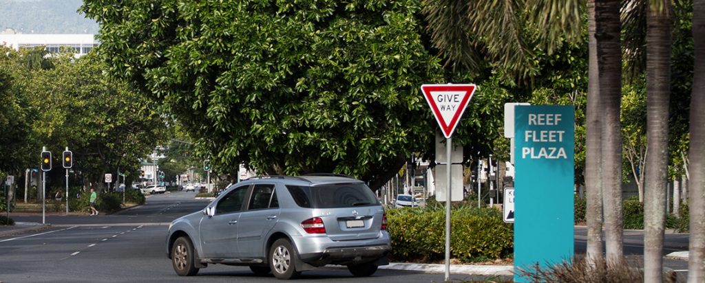 Car driving past Cairns reef terminal