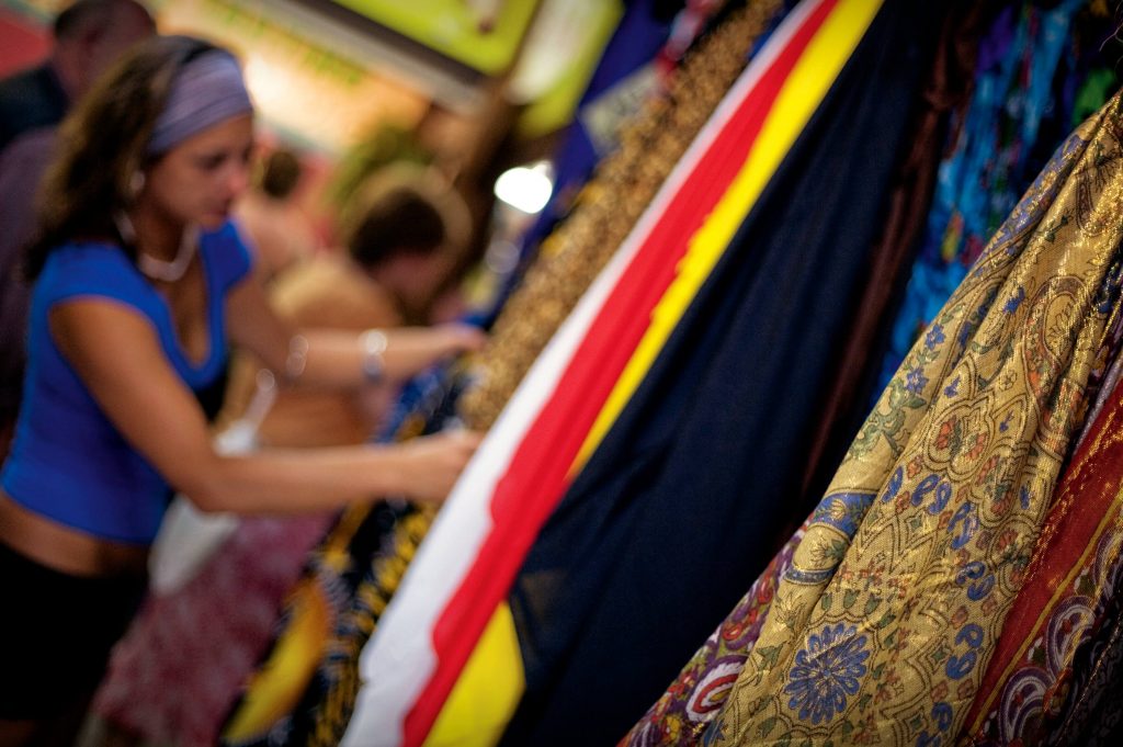 Woman looking at Scarfes at Cairns Night Market