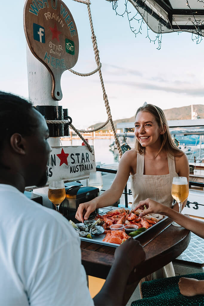 Friends enjoying seafood platter at Prawn Star Cairns