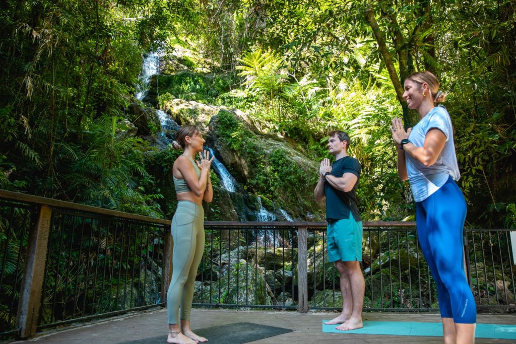 yoga next to waterfall at daintree eco lodge